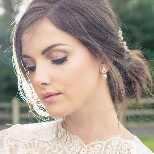  bride wearing small pearl earrings
